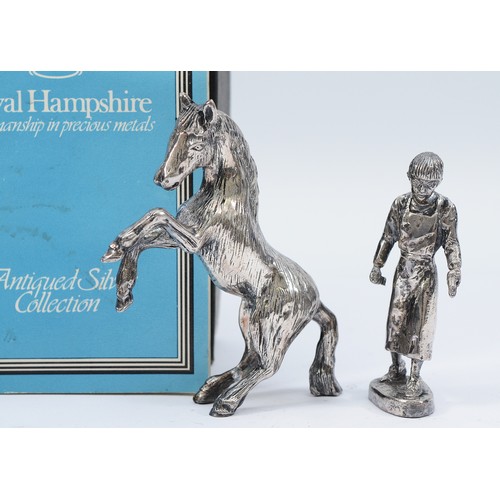 227 - Royal Hampshire, a silver model of a farrier, together with a silver rearing horse, stamped 'RH' fil... 