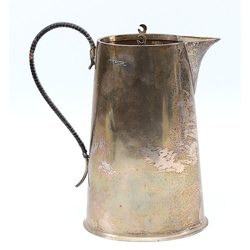 228 - A silver pitcher, Chester 1915, by the Barker Brothers, having a tapered cylindrical body, and a wic... 