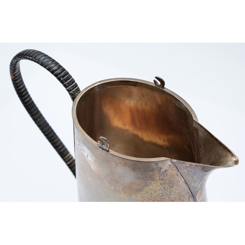 228 - A silver pitcher, Chester 1915, by the Barker Brothers, having a tapered cylindrical body, and a wic... 