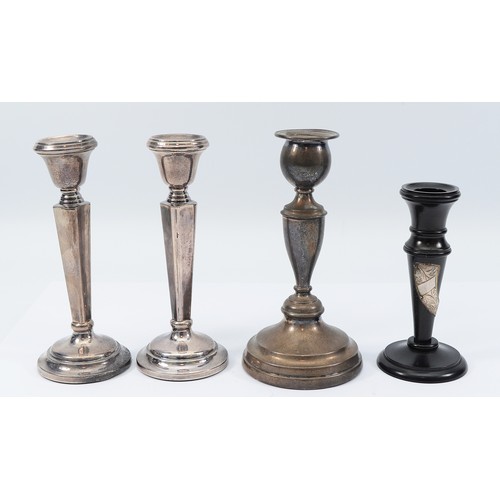 232 - A pair of silver candlesticks, Birmingham, date letter worn, loaded, together with a silver candlest... 