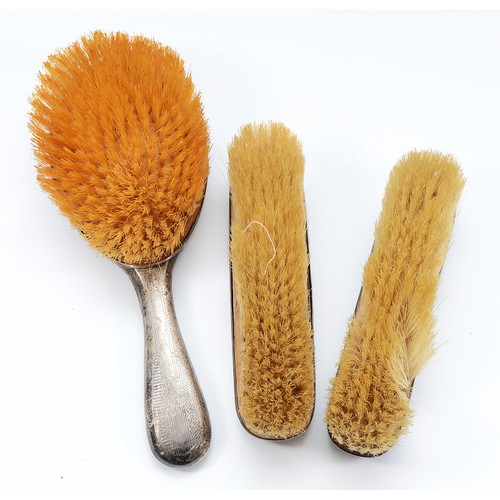 234 - A silver dressing table hair brush, Chester 1919, with engraved 'A' to the back together with a matc... 