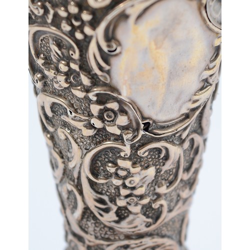 240 - A silver embossed trumpet vase, Birmingham 1903, by AE Goodby & Son, with blue glass liner, loaded,1... 