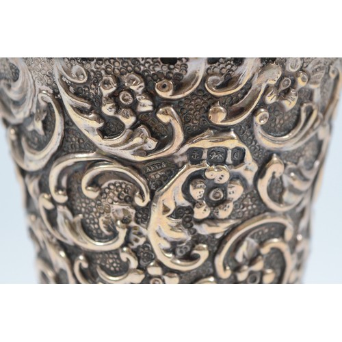 240 - A silver embossed trumpet vase, Birmingham 1903, by AE Goodby & Son, with blue glass liner, loaded,1... 