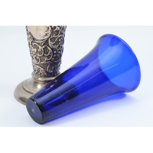 240 - A silver embossed trumpet vase, Birmingham 1903, by AE Goodby & Son, with blue glass liner, loaded,1... 