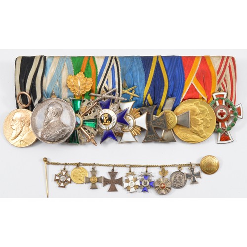 Bavarian/Prussian court mounted medal group of nine medals, including 1852-1902 Baden Jubilee 50th anniversary, Silver Bavarian Prince Regent Luitpold 'Für rettung' (For Rescue) medal, Order of the Zähringer Lion with swords, Knights 2nd class with the Jägertruppe beret badge, Friedrich Order Knights 1st class with swords, Brunswick 1914 War Merit Cross 2nd class, Prussian Army Long Service, Friedrich-Luisen Medal and the 1864-1914 Austro-Hungarian Honour Decoration of the Red Cross with the War Decoration wreath, together with miniatures, mounted on a pin and Godet button hole chain, label and mounted by J. Godet & Sohn.