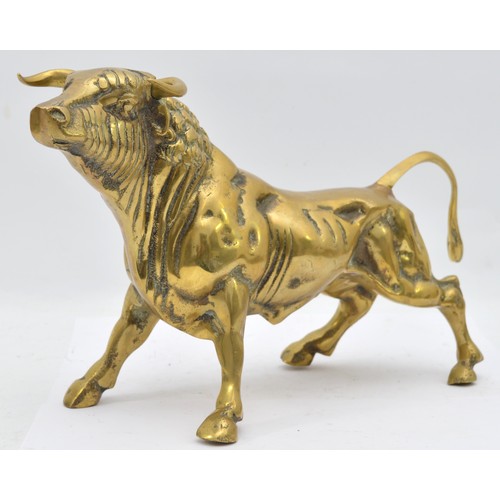 A large brass model of a bull, of substantial weight, likely used for ...