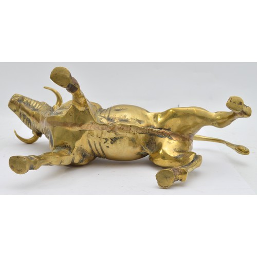 A large brass model of a bull, of substantial weight, likely used for ...