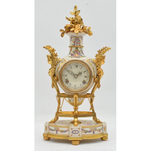 A Victoria & Albert Museum Marie-Antoinette Flowers of Versailles mantel clock, produced by Franklin Mint, the porcelain case surmounted by a gilt metal flower spray and caryatid handles, decorated with printed flowers and ribbon motifs, brass bezel set with crystal jewels, the dial with Roman and Arabic chapter, eight-day movement striking on a bell, height 42cm.
