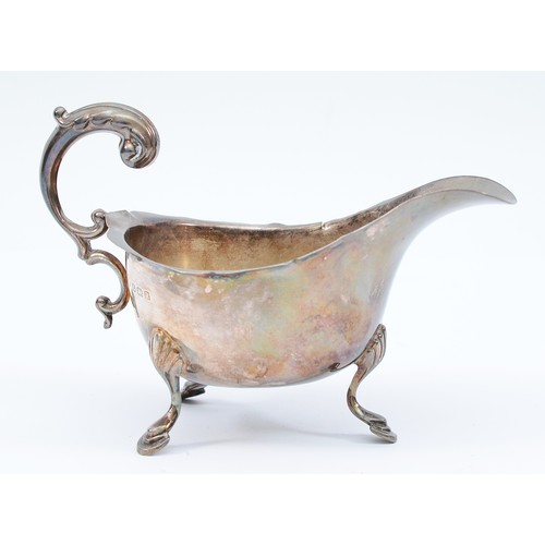 66 - A silver milk jug, Birmingham 1941, by S Blanckensee & Son Ltd, raised on three legs, 141gm, 14x8cm.... 