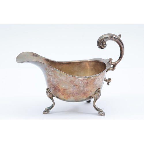 66 - A silver milk jug, Birmingham 1941, by S Blanckensee & Son Ltd, raised on three legs, 141gm, 14x8cm.... 