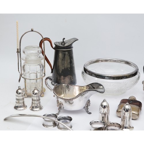 71 - A large quantity of silver plated wares to include, a plated ewer, having wicker handle, a plated gr... 
