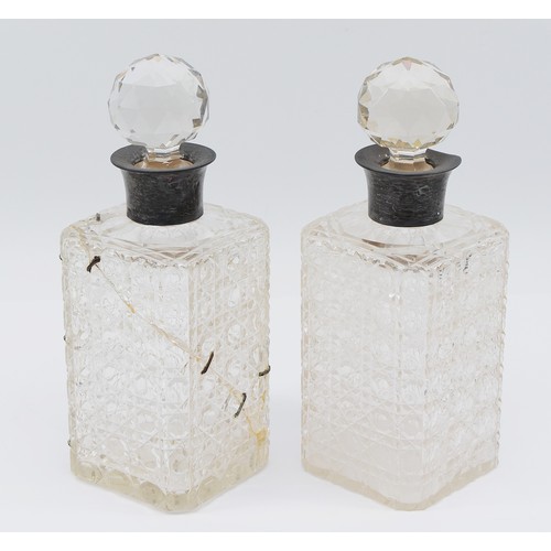 72 - A pair of cut glass decanters with silver collars, Birmingham 1926, by John Grinsell & Sons, one dec... 