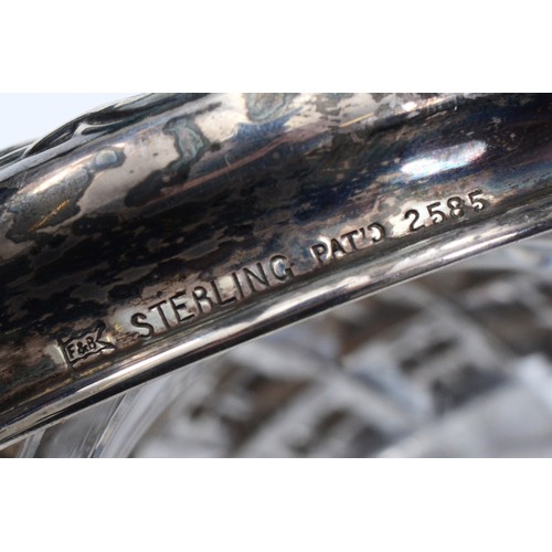 77 - A cut glass powder jar, with embossed silver lid of a lady in a hammock, marked sterling silver, lid... 