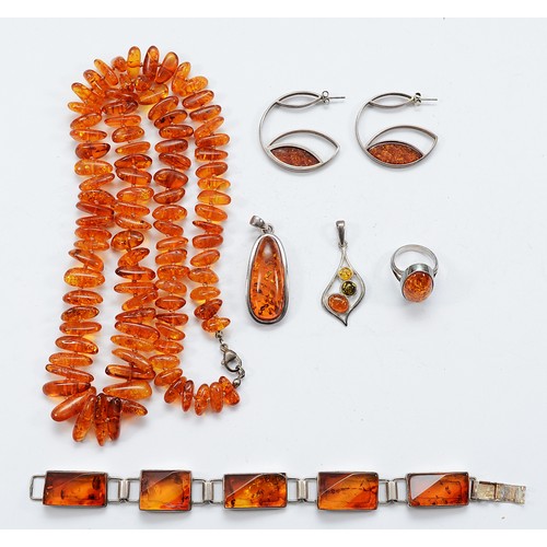 99 - A 925 silver clasped amber necklace, a 925 silver amber panel bracelet, two 925 silver amber pendant... 
