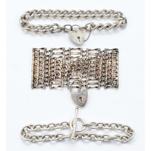 110 - A silver curb link bracelet with heart padlock clasp, Birmingham 1971, a 925 silver gate link bracel... 
