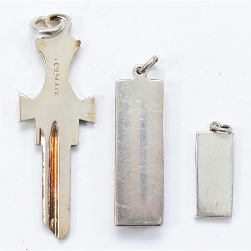 115 - A silver ingot pendant, Birmingham 1979, a silver ingot key pendant, Birmingham 1978 and a silver in... 