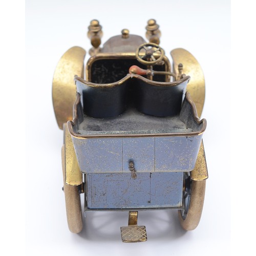 27 - A vintage brass and tin model of a brass era car cigarette container, green leather seats, lift up r... 