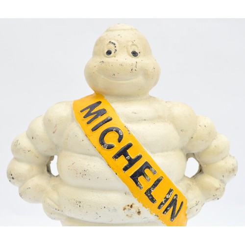 41 - A painted cast iron Michelin man on a wheel, 38cm.