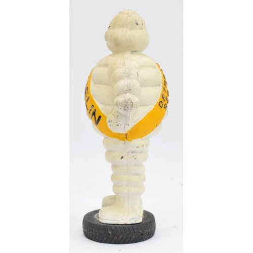 41 - A painted cast iron Michelin man on a wheel, 38cm.