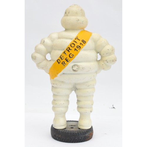 41 - A painted cast iron Michelin man on a wheel, 38cm.