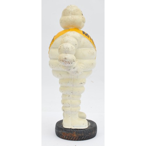 41 - A painted cast iron Michelin man on a wheel, 38cm.