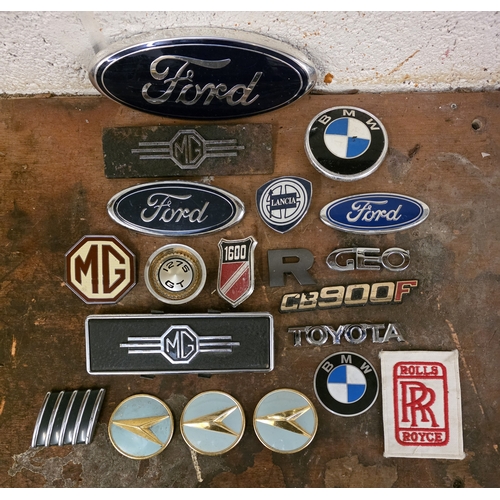 A collection of twenty car badges