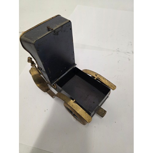 27 - A vintage brass and tin model of a brass era car cigarette container, green leather seats, lift up r... 