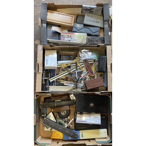 43 - Three boxes of measuring and marking equipment, to include, slide rules, tape measures and dividers.... 