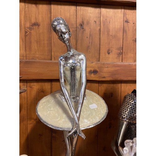 60 - A metal sculpture six bottle wine rack of a musician playing a cello 67.5cm high, a chrome five arm ... 