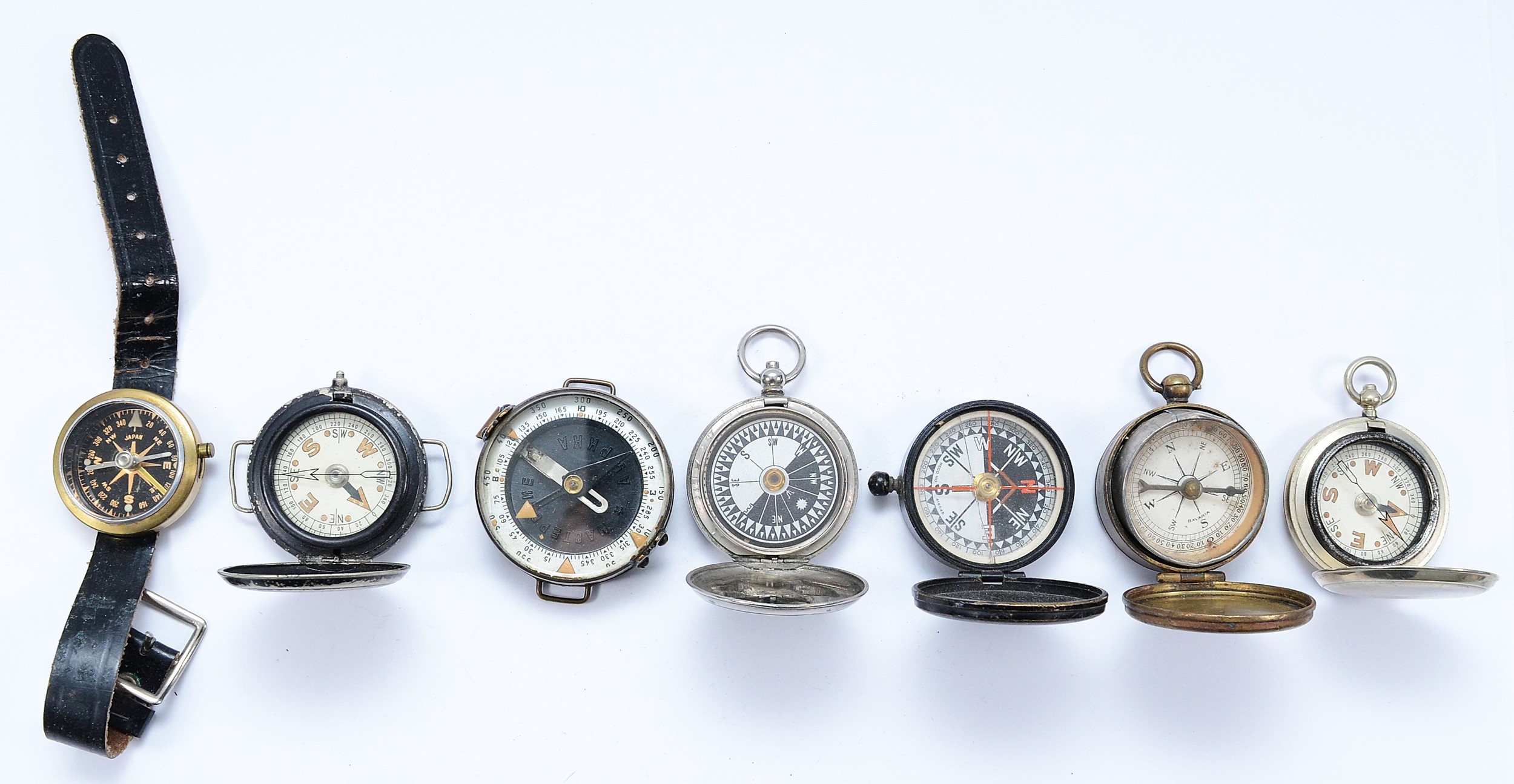 A collection of seven early 20th century and later compasses, wrist and ...