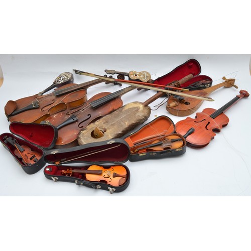 A collection of stringed musical instruments, to include violins, cased ...
