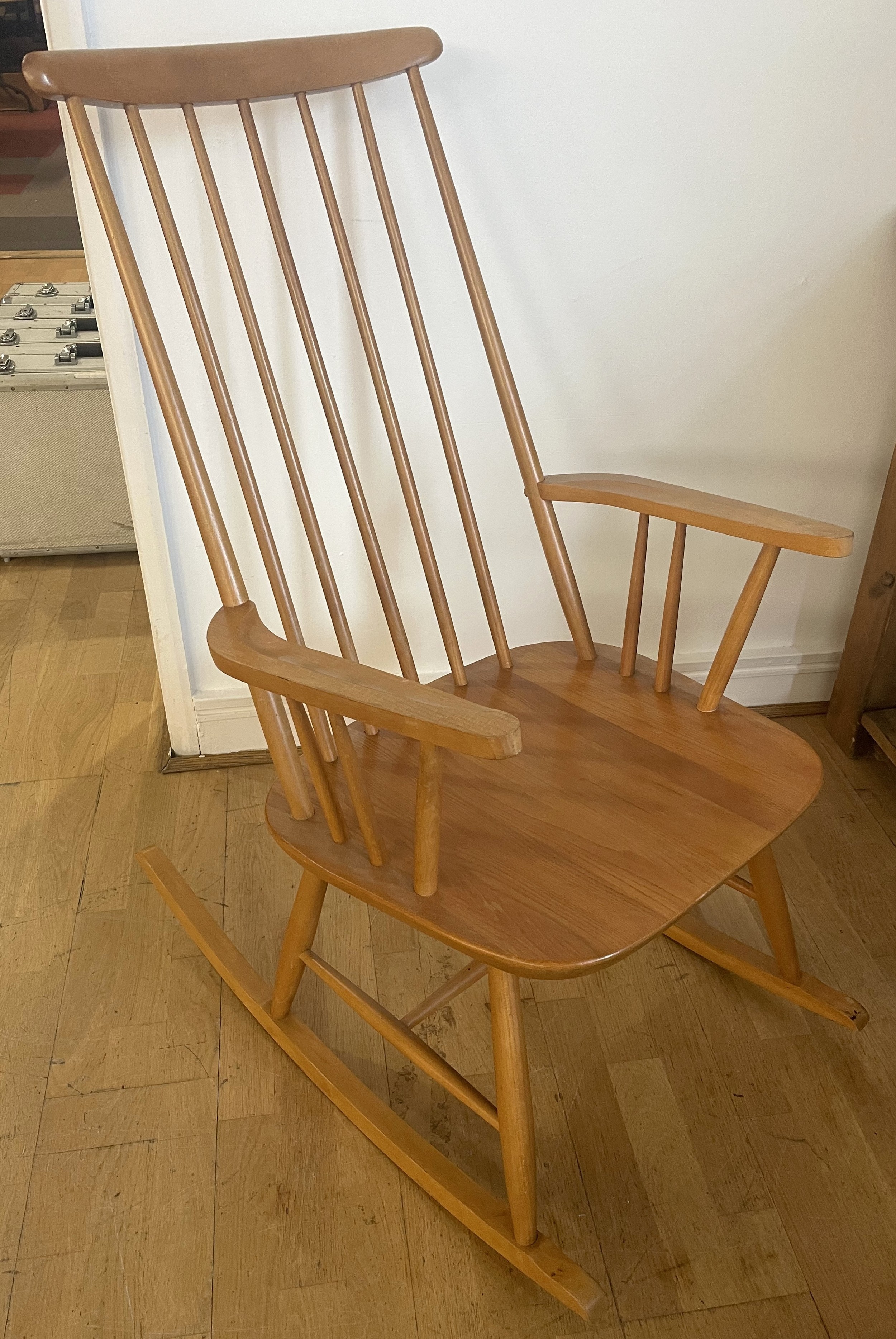 A late 20th century beech Windsor rocker chair, having high spindle ...