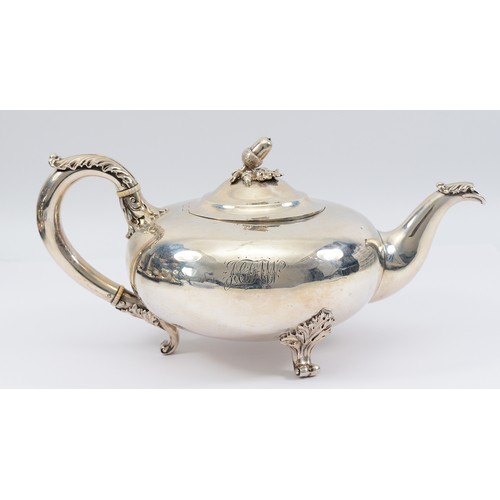 A Victorian silver tea pot, London 1839, by Robert Hennell III, raised on three cabriole legs, having a decorative foliate handle and spout, with acorn decoration to the lid, and engraved initials to the side, 30x14cm, 700gm.