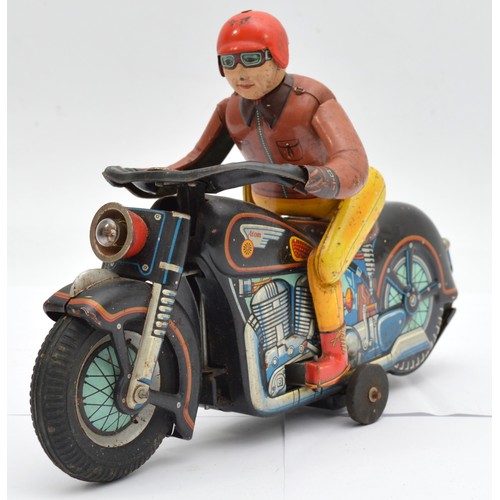 A 1960s Modern Toys Masudaya 'Atom Racer' battery operated lithographed tinplate motorcycle & rider figure from Japan, trick action rider dismounts, swings their leg over and remounts the bike, which then moves forward, repeating the sequence, 29cm long.