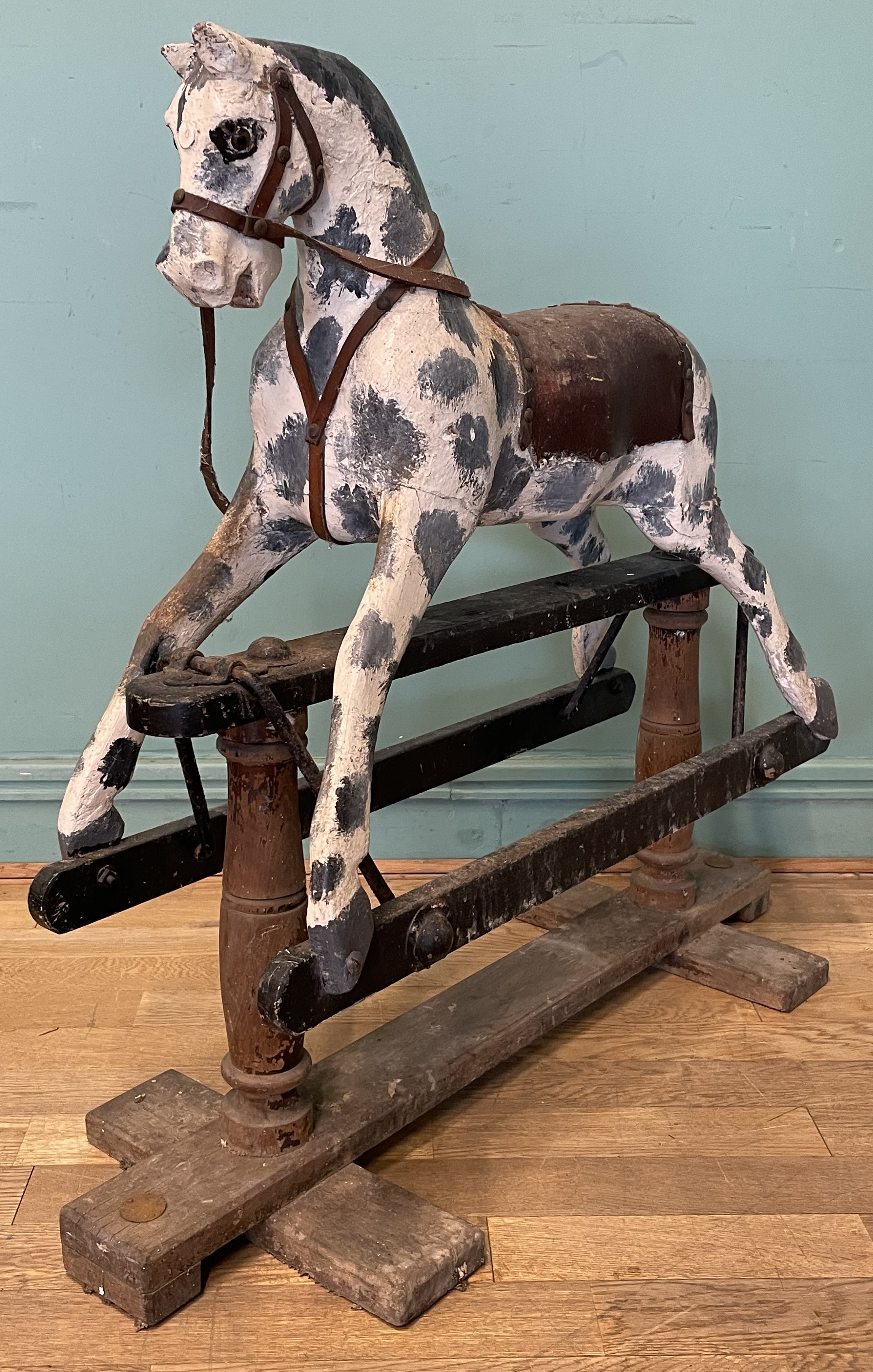An early 20th century dapple grey rocking horse, carved wood with a ...