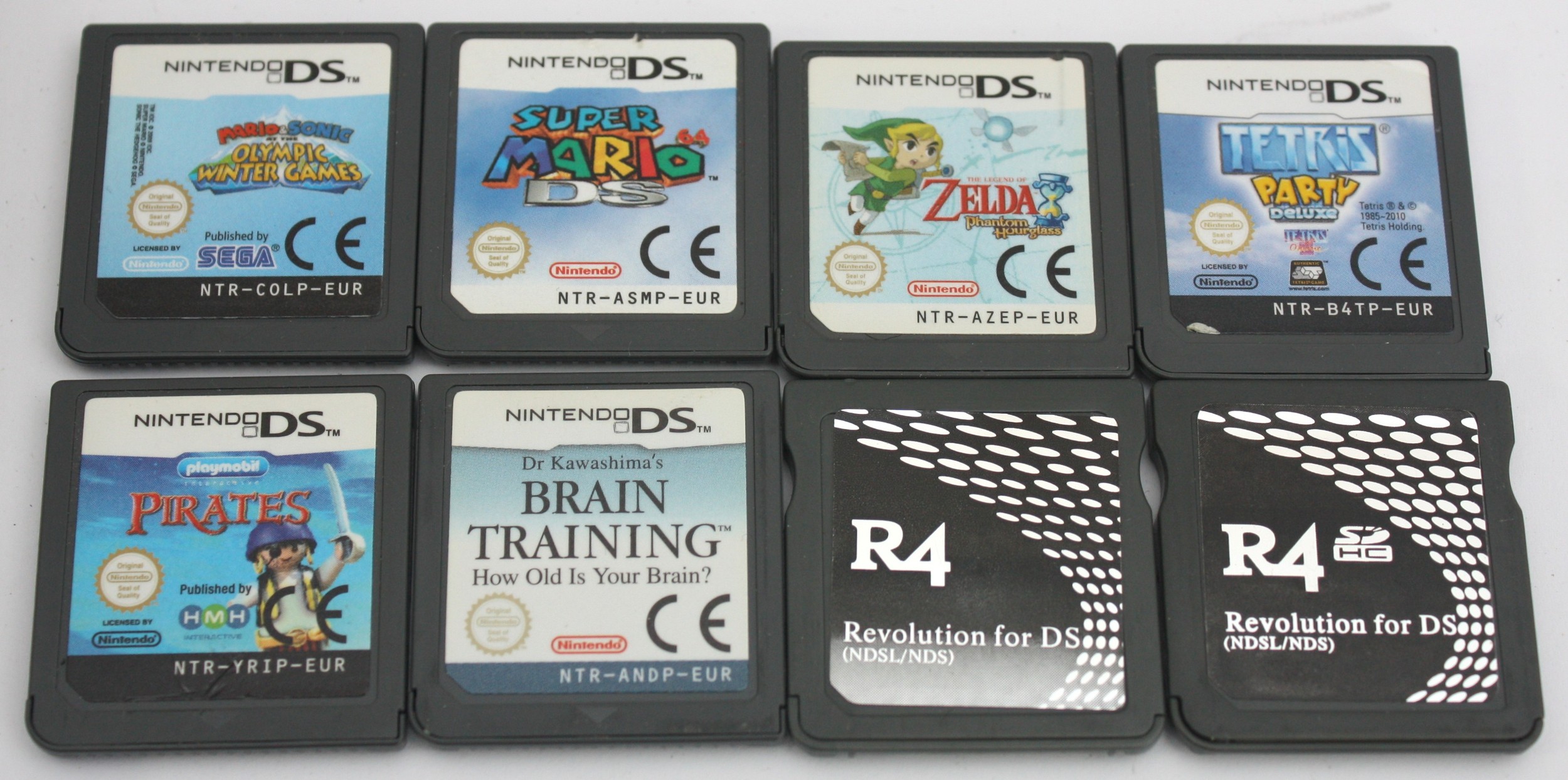 Three Nintendo DS handhelds and seven games to include two white DS ...