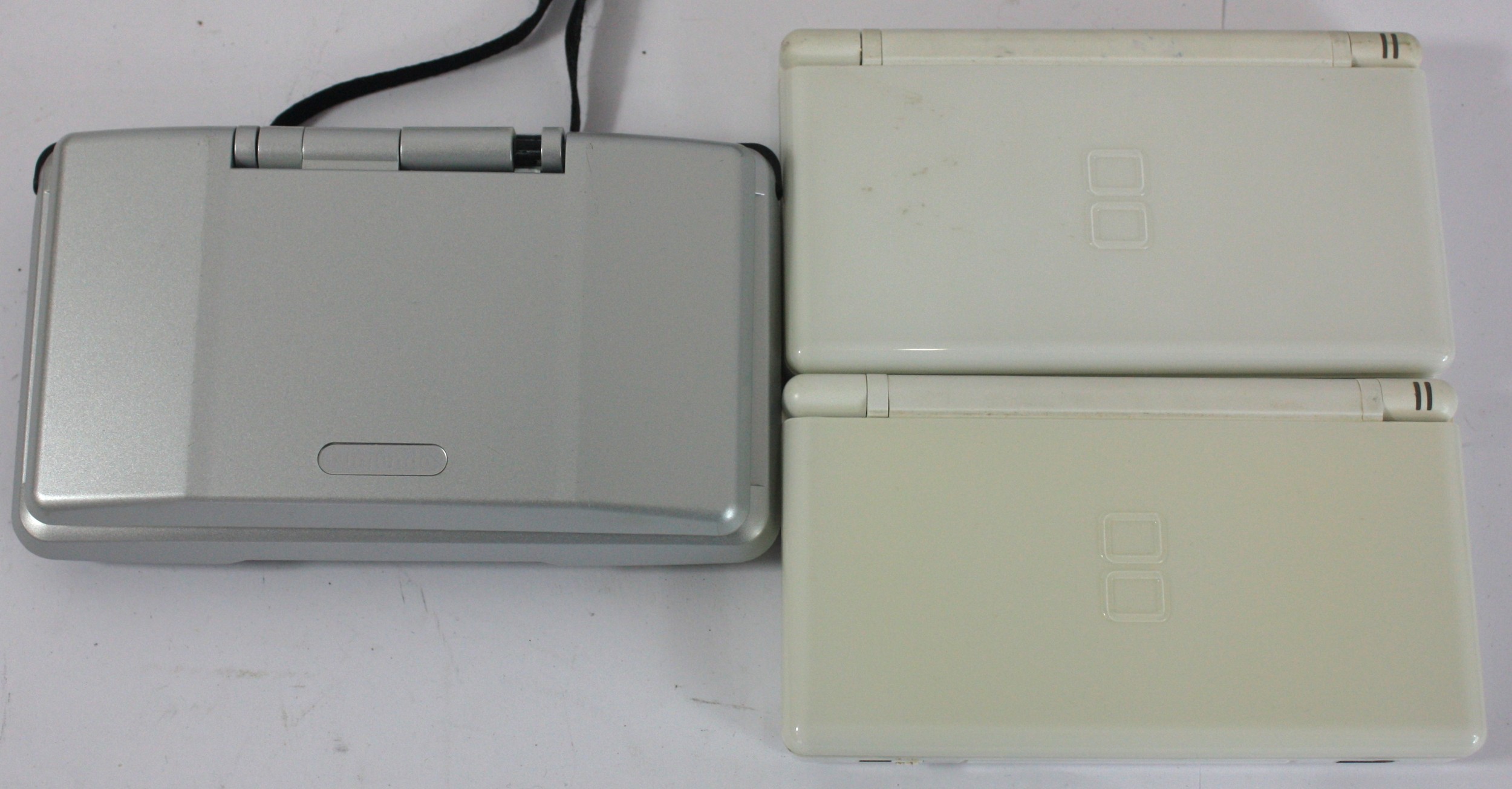 Three Nintendo DS handhelds and seven games to include two white DS ...