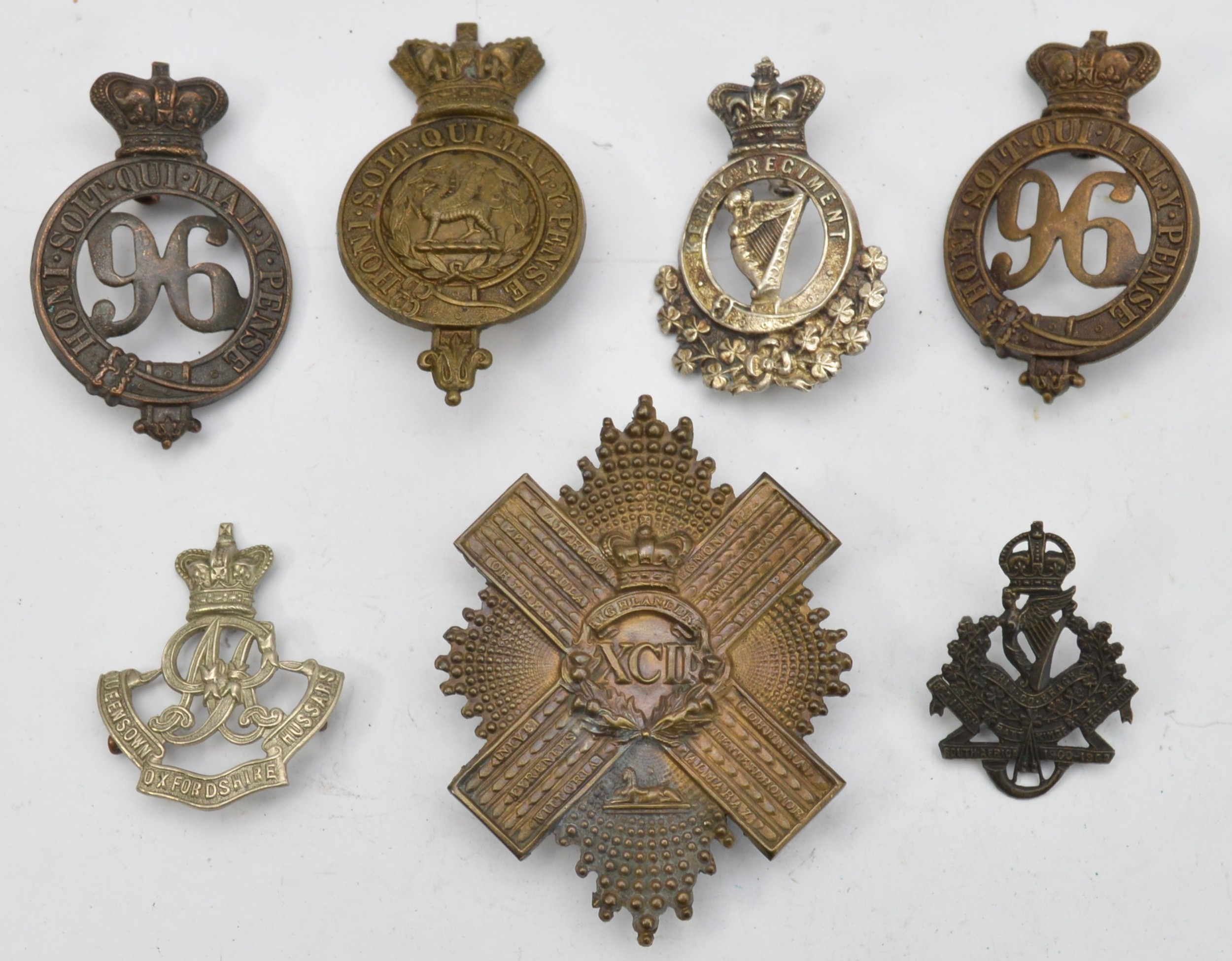 A collection of seven Victorian military cap badges to include the 92nd ...