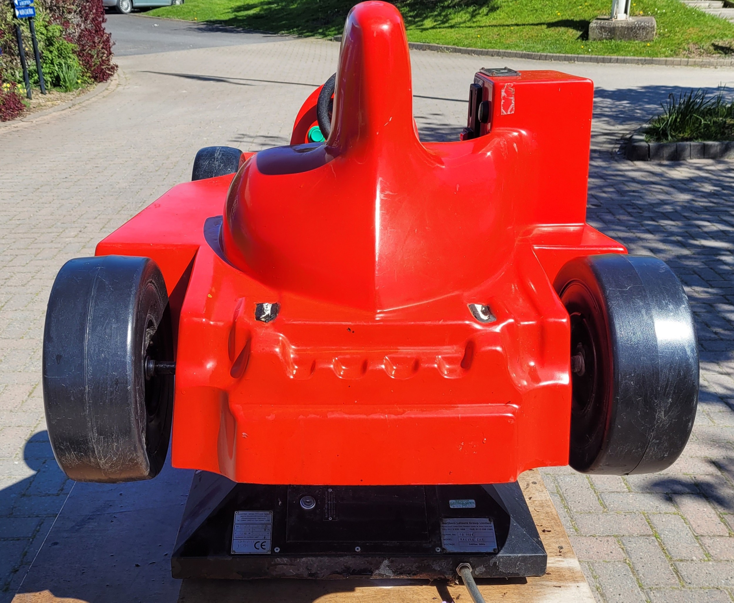 A 1970s coin operated children's ride, styled after a Formula 1 racing ...