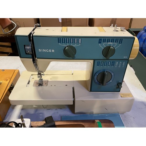 A Singer 3013 sewing machine and a Janome sewing machine. (2)