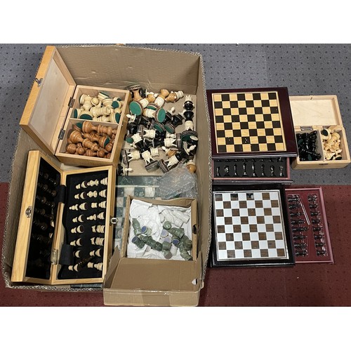 A collection of various modern chess sets, including loose chess pieces ...