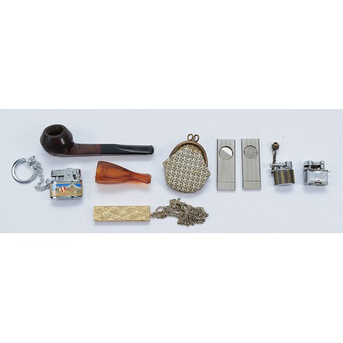 A group of smokerama collectables, including cigar cutters, a Monty pipe,  keyring cigarette lighters
