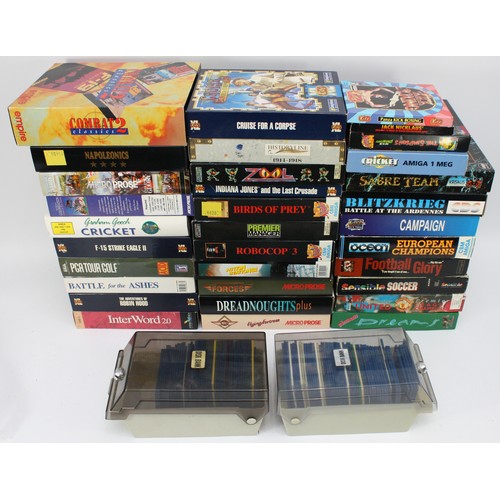 33 Boxed Amiga games and 2 containers of loose floppy discs to include ...