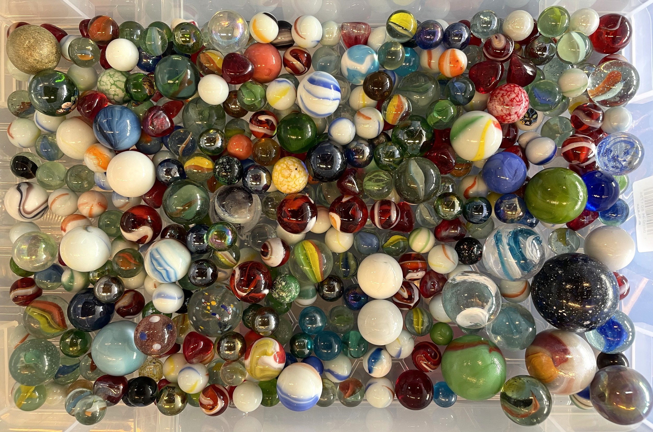 A large collection of various types of vintage and modern marbles ...