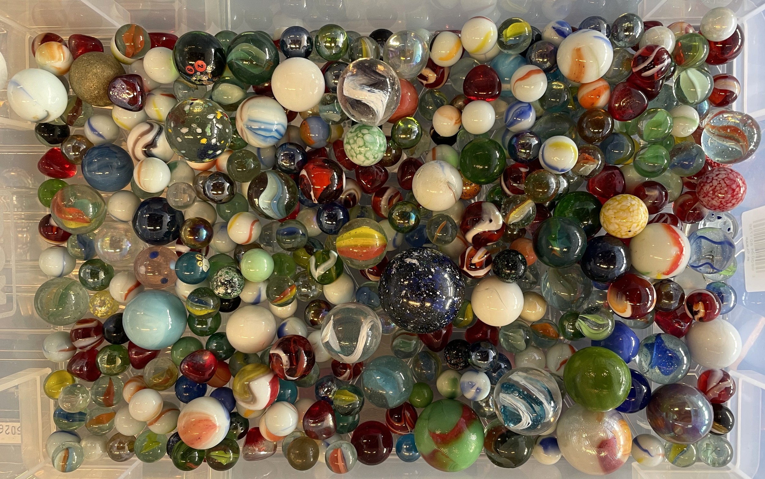 A large collection of various types of vintage and modern marbles ...