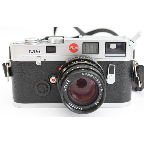 A Leica M6 film camera, made in Germany, no. 1755704, with a Leitz Summicron-M 1:2/50 lens, case and instruction manual.