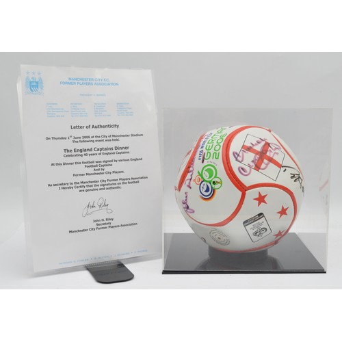 Of England Football interest; a signed FIFA Germany 2006 charity dinner presentation football, signed by past England captains and Manchester City players, to include Alan Mullery, Malcolm MacDonald, Ron Harris, Gordon Banks, Ron Flowers, Jimmy Armfield, David Seaman, Bryan Robson, Tony Adams, Peter Shilton, Alan Ball and others, case, certificate of authenticity.