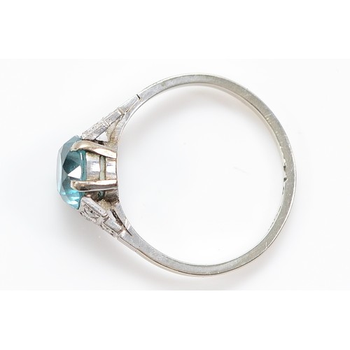 1 - An Art Deco 18ct white gold blue zircon single stone ring, white stone stepped shoulders, K, 2.2g