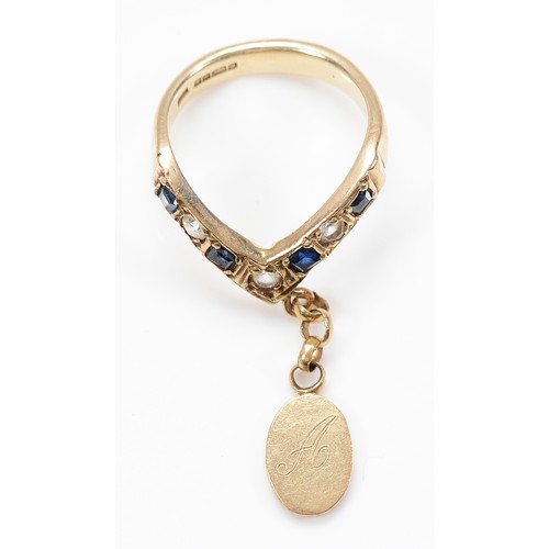 5 - A 9ct gold sapphire and white gemstone wishbone ring with charm, Sheffield 1994, L, 4.3g