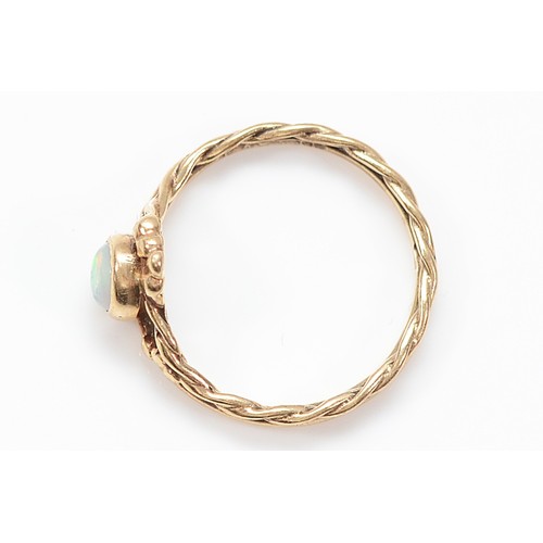 6 - A 9ct gold opal twisted band ring, K 1/2, 1.8g